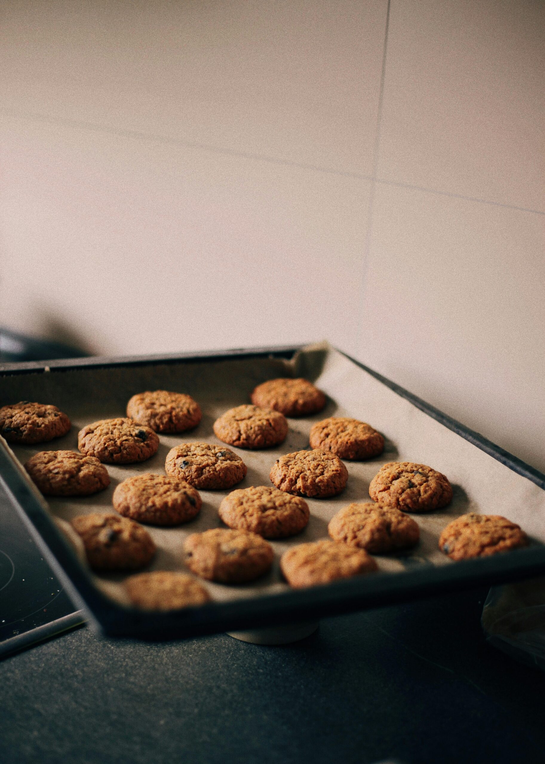 Home A tray of home-baked cookies cooling in a cozy kitchen setting.